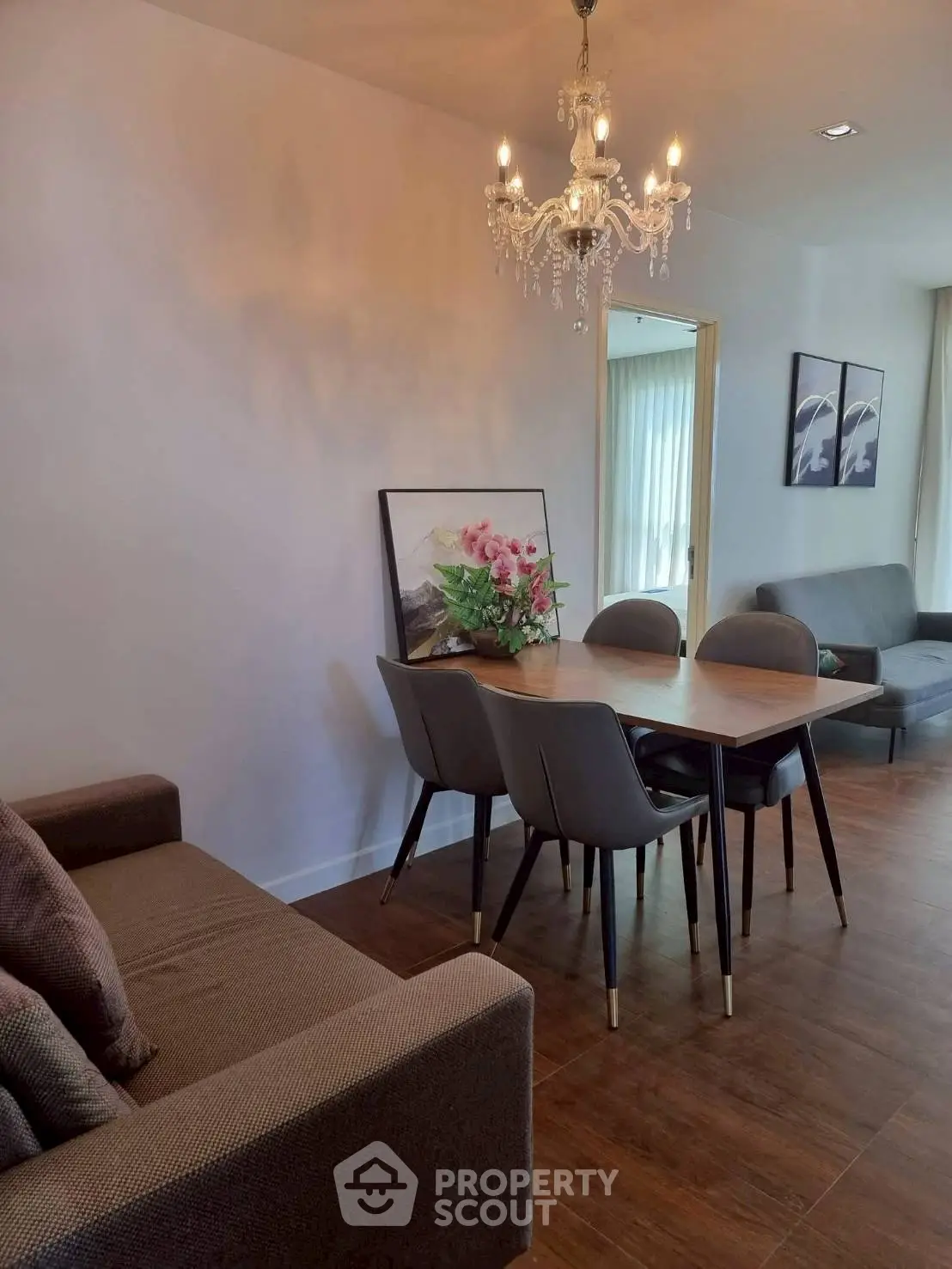 Elegant dining area with chandelier and modern decor in a cozy living space.