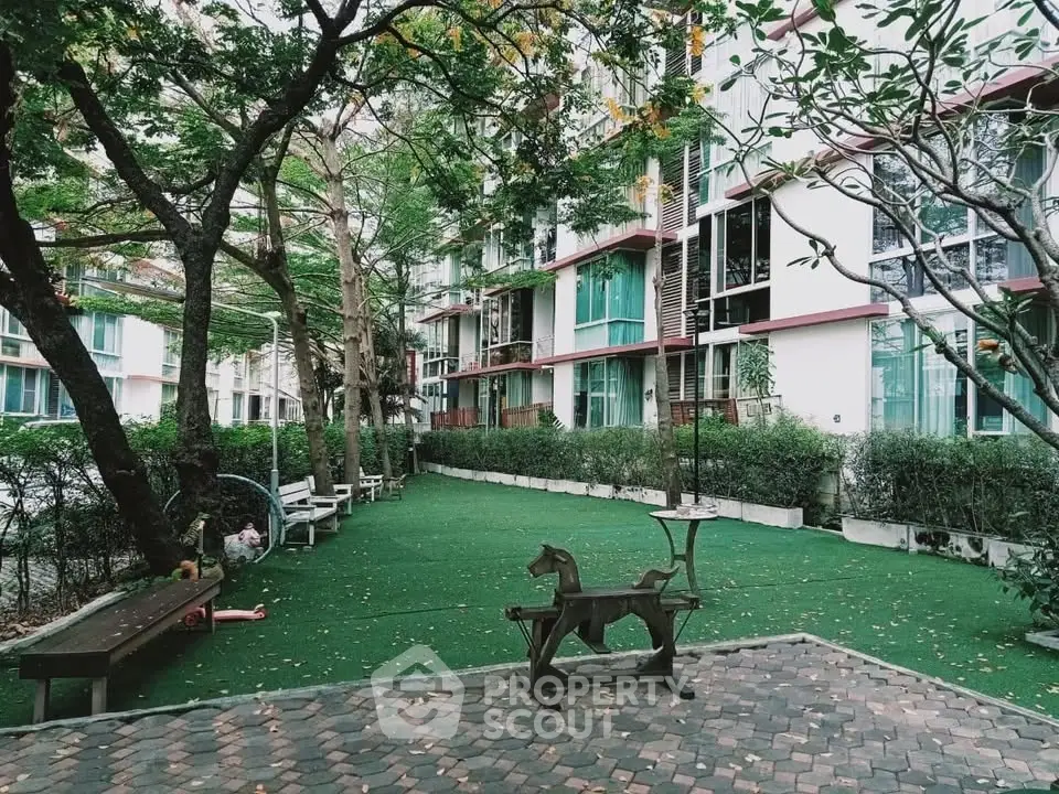 Charming residential building with lush garden and play area, perfect for families seeking tranquility and comfort.