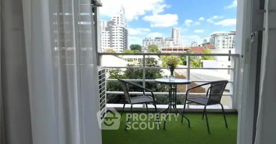 Charming balcony with city view, perfect for relaxation and enjoying the skyline.