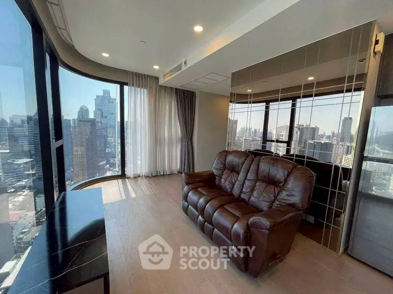 Luxurious high-rise living room with stunning city view and elegant furnishings.