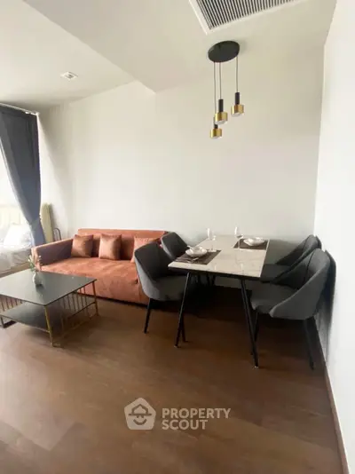 Modern living room with stylish furniture and elegant dining area, perfect for urban living.