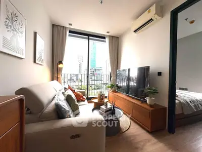 Modern living room with city view, cozy sofa, and stylish decor in a high-rise apartment.