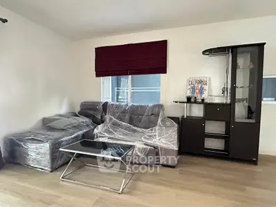 Modern living room with wrapped furniture and sleek decor