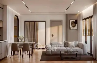 Modern living room with elegant decor and open layout, featuring a cozy sofa and stylish dining area.