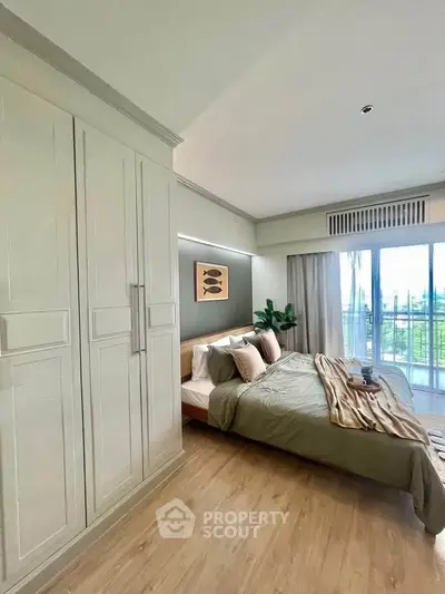 Spacious bedroom with elegant decor and balcony view