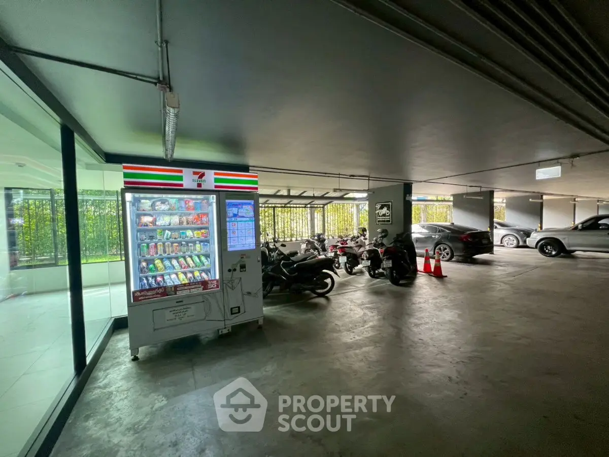 Modern parking area with vending machine and motorcycles, spacious and well-lit.