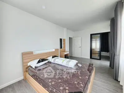 Spacious modern bedroom with elegant decor and natural light