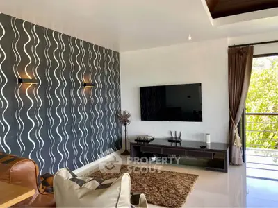 Modern living room with stylish wallpaper, large TV, and balcony view.