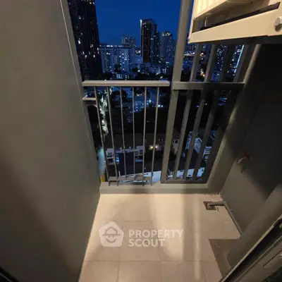 Charming balcony with stunning city skyline view at night, perfect for relaxation and enjoying urban living.