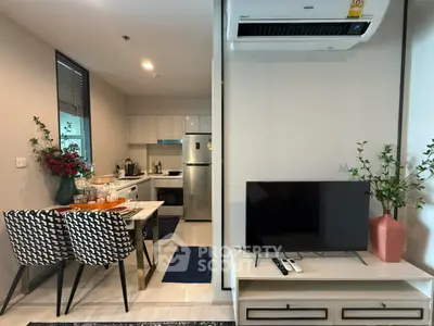 Modern open-plan living room and kitchen with stylish decor and appliances