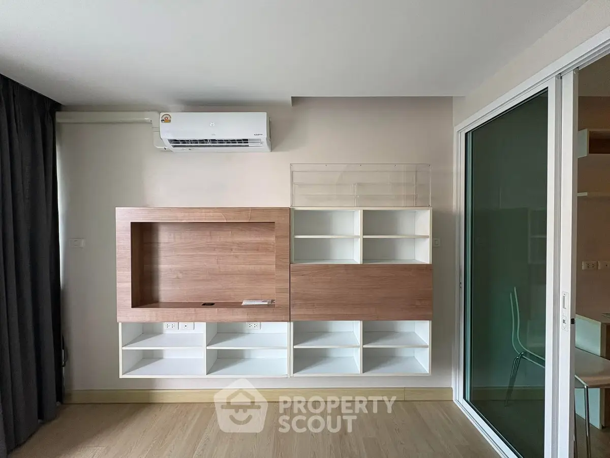 Modern living room with sleek built-in shelving and air conditioning unit, perfect for contemporary living.