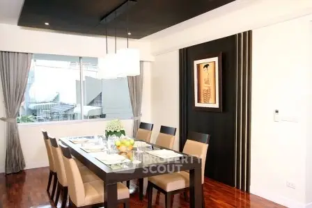 Elegant dining room with modern decor and large window view