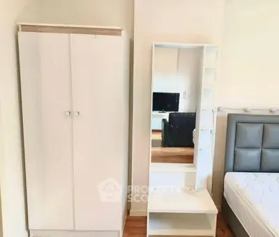 Modern bedroom with sleek wardrobe and stylish headboard, perfect for urban living.