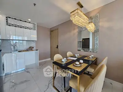 Luxurious dining area with elegant chandelier and modern kitchen in a stylish apartment.