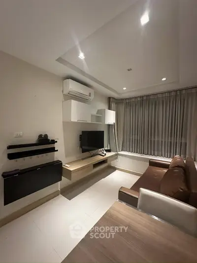 Modern living room with sleek furniture and ambient lighting, perfect for cozy evenings.