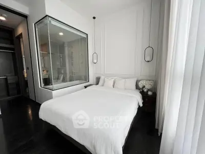 Modern bedroom with glass-walled bathroom and elegant decor