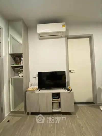 Modern living room with sleek furniture and air conditioning unit, perfect for cozy urban living.