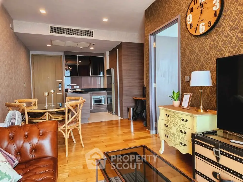 Chic living room with vintage decor and open kitchen layout in modern apartment.