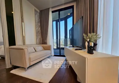 Modern living room with elegant decor and balcony view, featuring a cozy sofa and sleek TV stand.