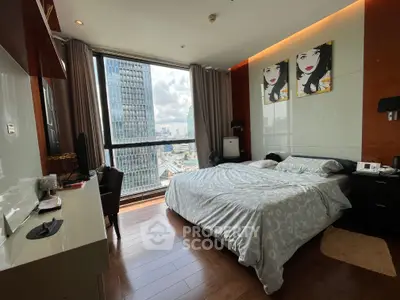 Luxurious bedroom with stunning city view and modern decor in high-rise apartment.