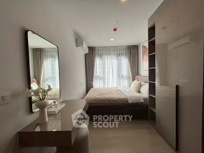 Modern bedroom with stylish decor and large window for natural light