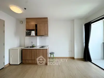 Modern kitchen with wooden cabinets and open layout in bright apartment