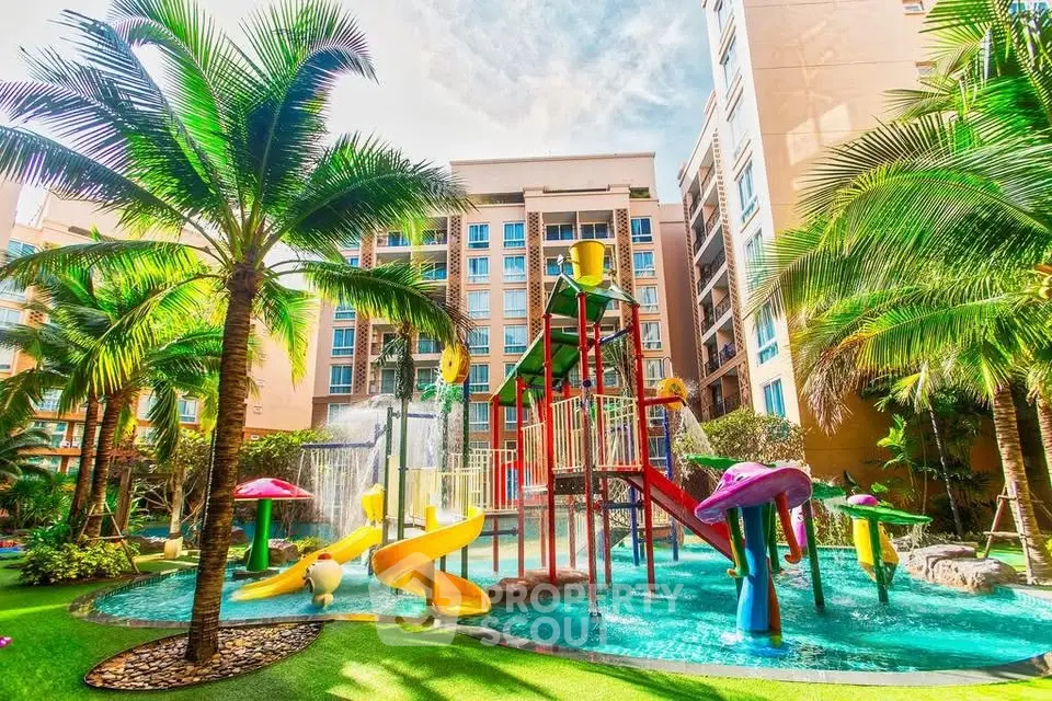 Vibrant apartment complex with colorful playground and lush palm trees