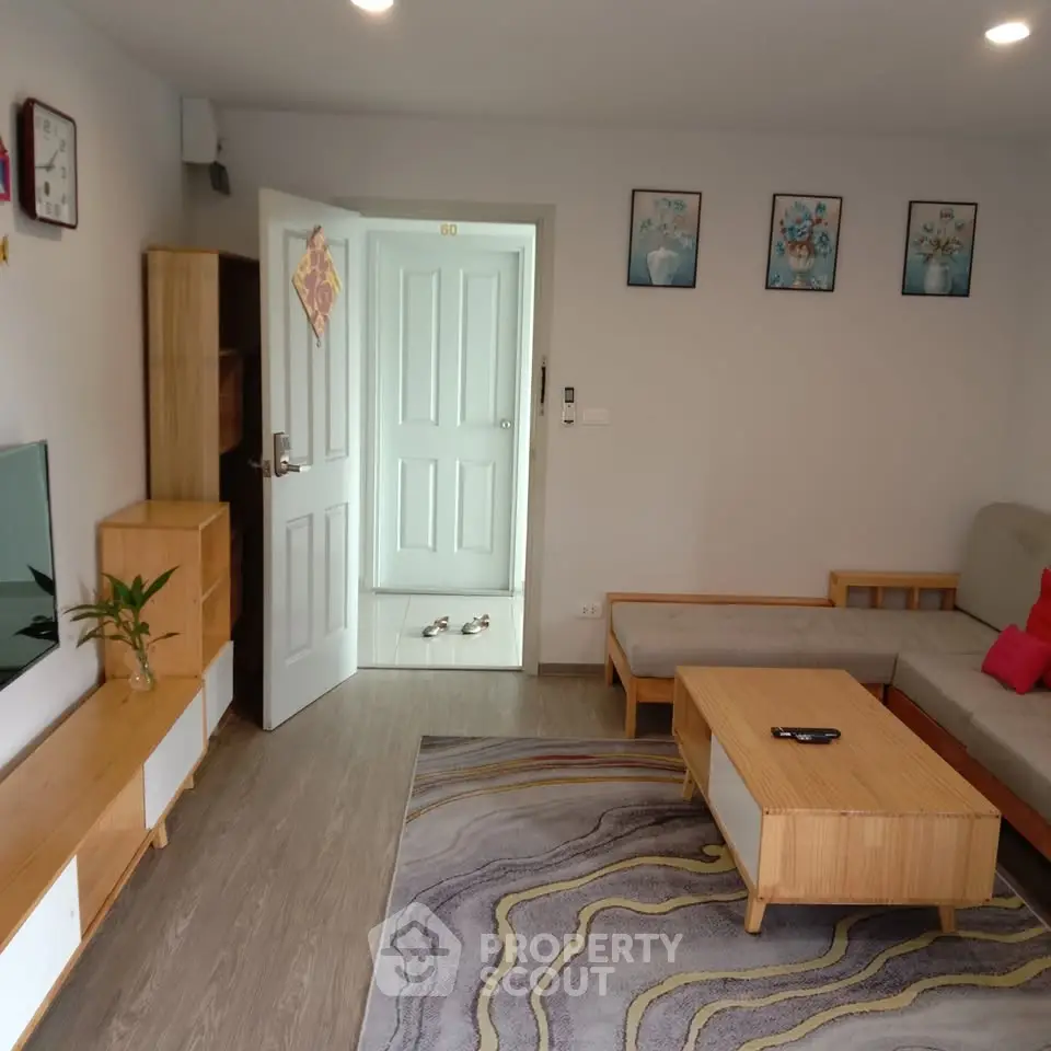 Modern living room with stylish furniture and decor, featuring a cozy sofa and elegant wooden accents.