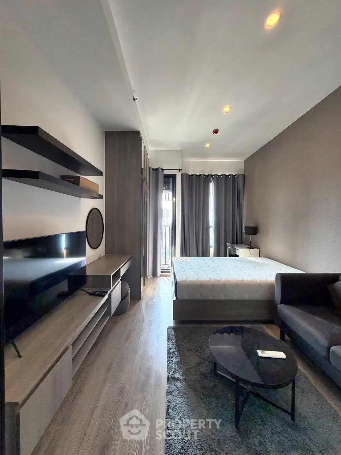 Modern bedroom with sleek furniture and large window for natural light