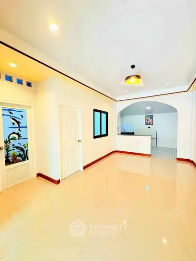 Spacious modern living room with elegant lighting and tiled flooring