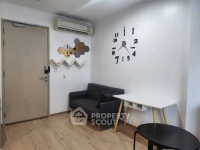 Modern living room with stylish decor and wall clock, featuring a cozy sofa and minimalist furniture.