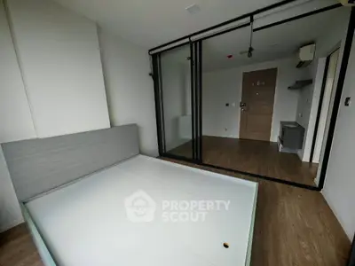 Modern minimalist bedroom with glass partition and wooden flooring