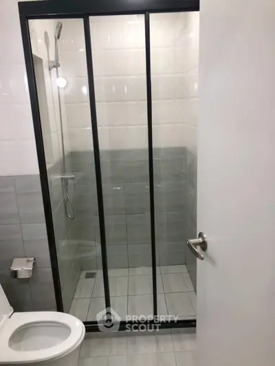 Modern bathroom with sleek glass shower and tiled walls