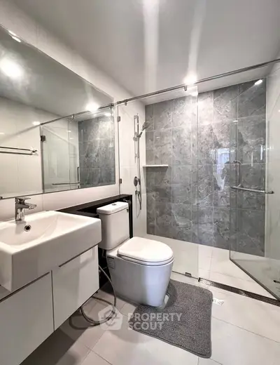 Modern bathroom with sleek fixtures and glass shower enclosure