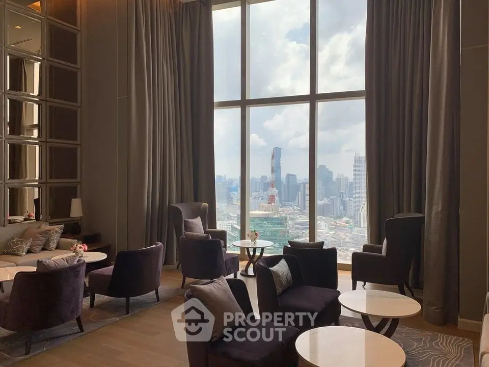 Luxurious high-rise living room with stunning cityscape view through large windows.