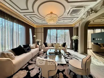 Luxurious living room with elegant decor and large windows offering natural light.