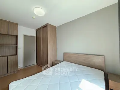 Spacious bedroom with modern wooden furniture and ample natural light