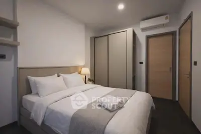 Modern bedroom with cozy bed, stylish wardrobe, and ambient lighting for a relaxing atmosphere.