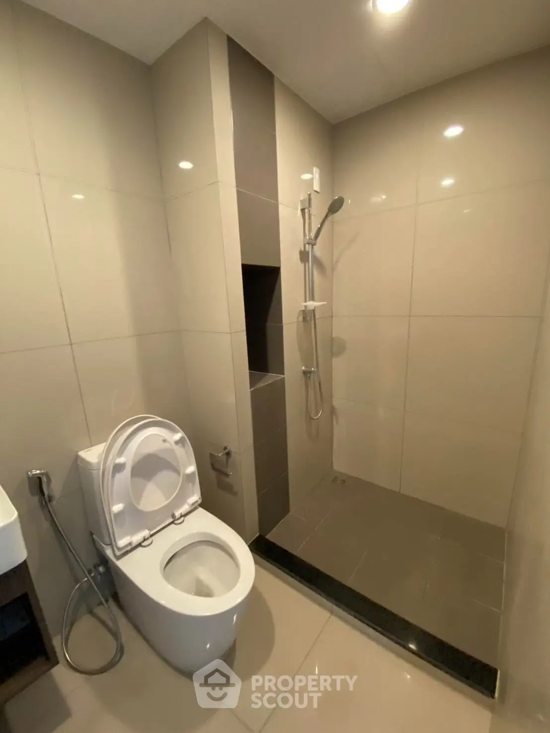 Modern bathroom with sleek shower and toilet in contemporary apartment