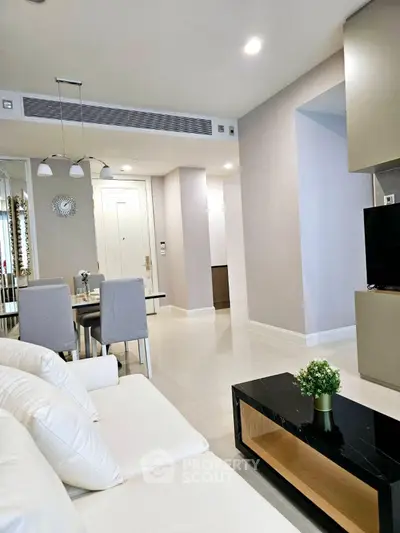 Modern living room with elegant dining area and stylish decor in a contemporary apartment.