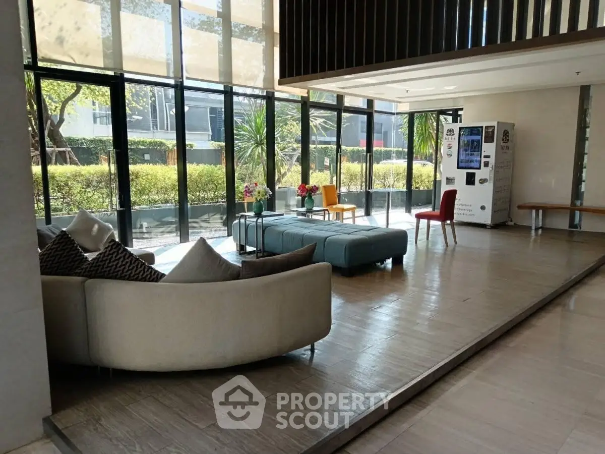 Spacious modern lobby with stylish seating and large windows overlooking greenery.