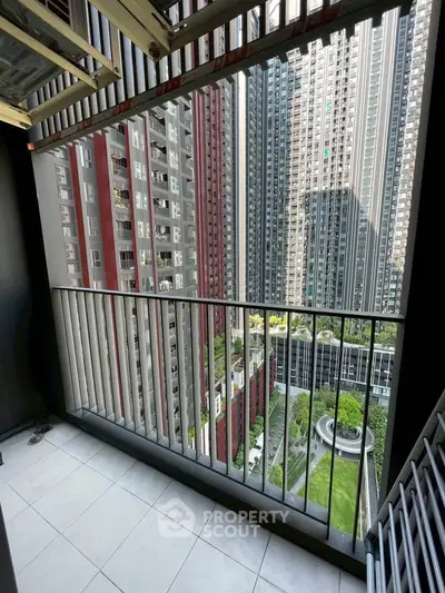 Stunning balcony view of modern high-rise buildings and lush garden below.