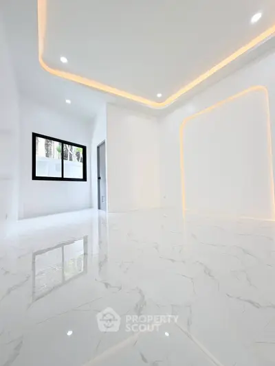 Modern minimalist interior with marble flooring and recessed lighting