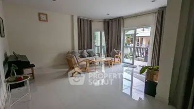 Spacious living room with modern furniture and large windows for natural light.