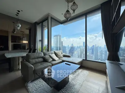Luxurious living room with panoramic city view and elegant decor in high-rise apartment.
