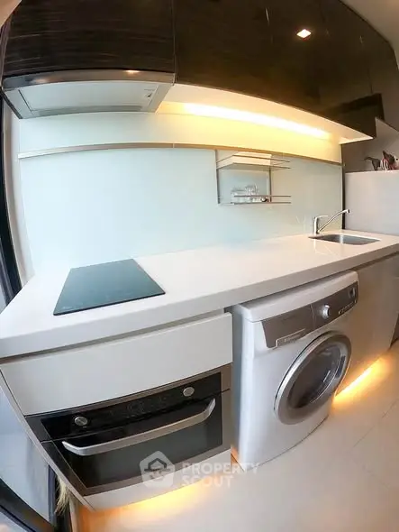 Modern kitchen with sleek appliances and under-cabinet lighting