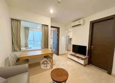 Modern living room with dining area and city view, featuring sleek furniture and neutral tones.