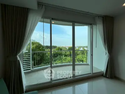Spacious balcony with stunning green view and sliding glass doors