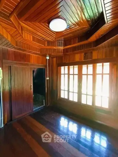 Stunning wooden interior with rich textures and natural light, perfect for a cozy living space.