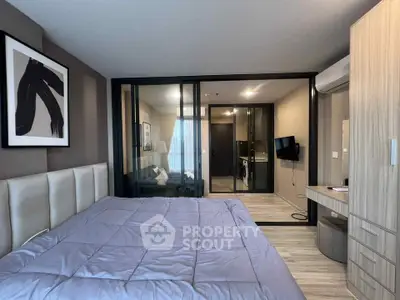 Modern bedroom with glass partition, stylish decor, and cozy ambiance.